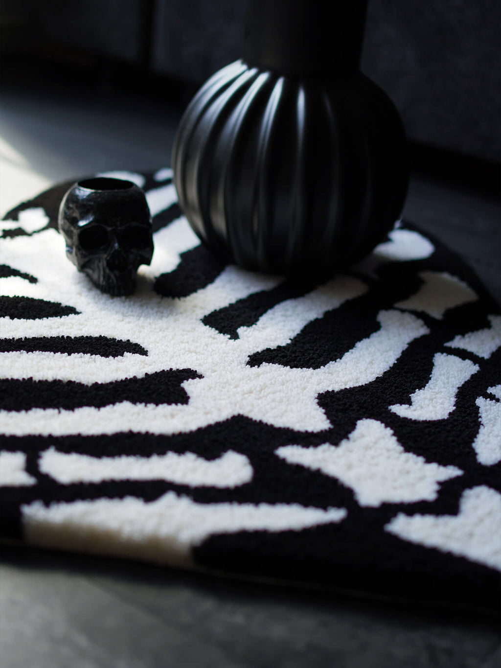 The Ribcage Heart Rug styled in a dark alternative living room with a skull & goth home decor.