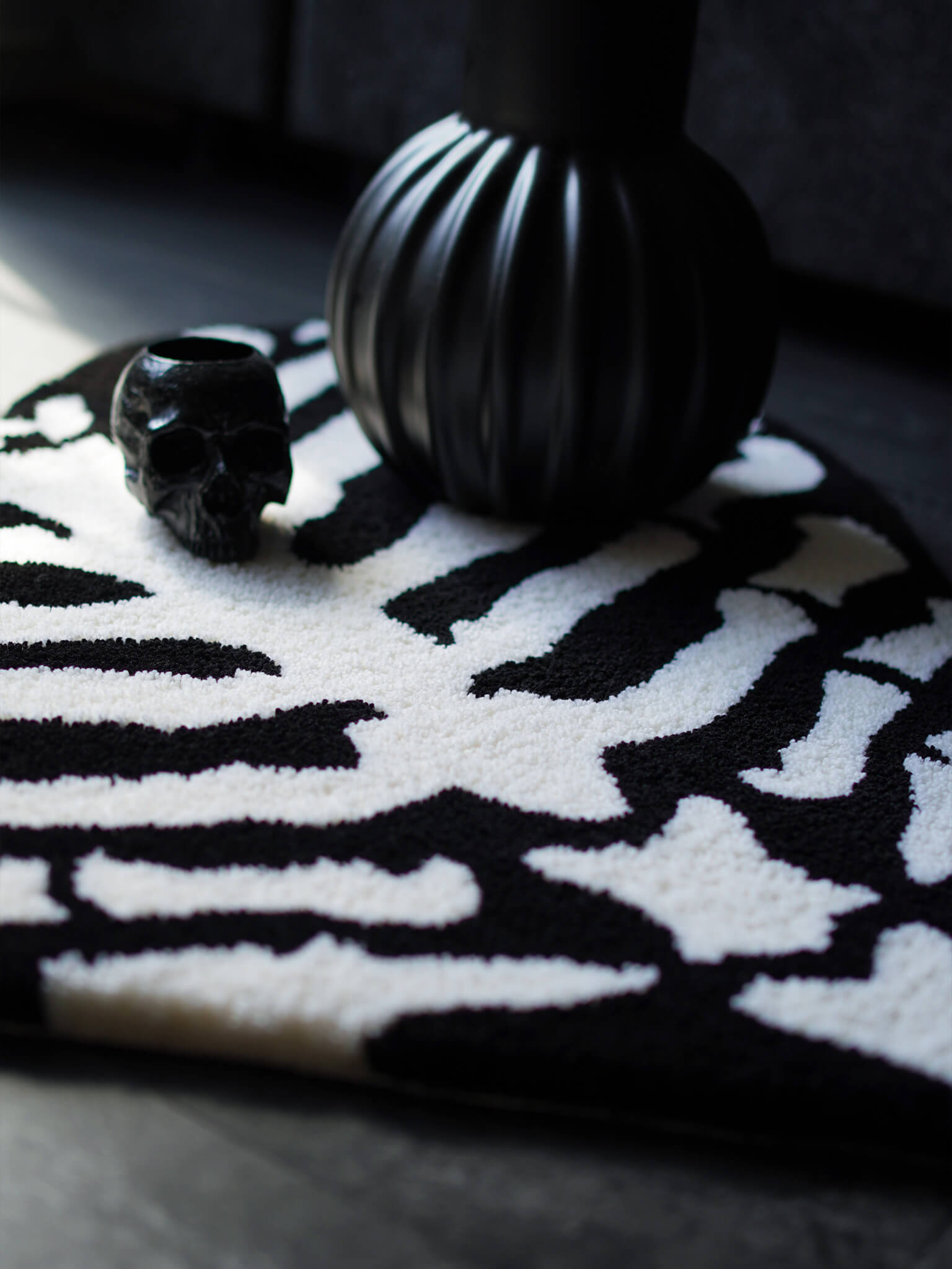 The Ribcage Heart Rug styled in a dark alternative living room with a skull & goth home decor.