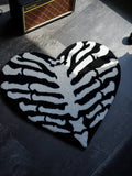 The Ribcage Heart Rug styled in a dark alternative room, perfect for underground interior design.