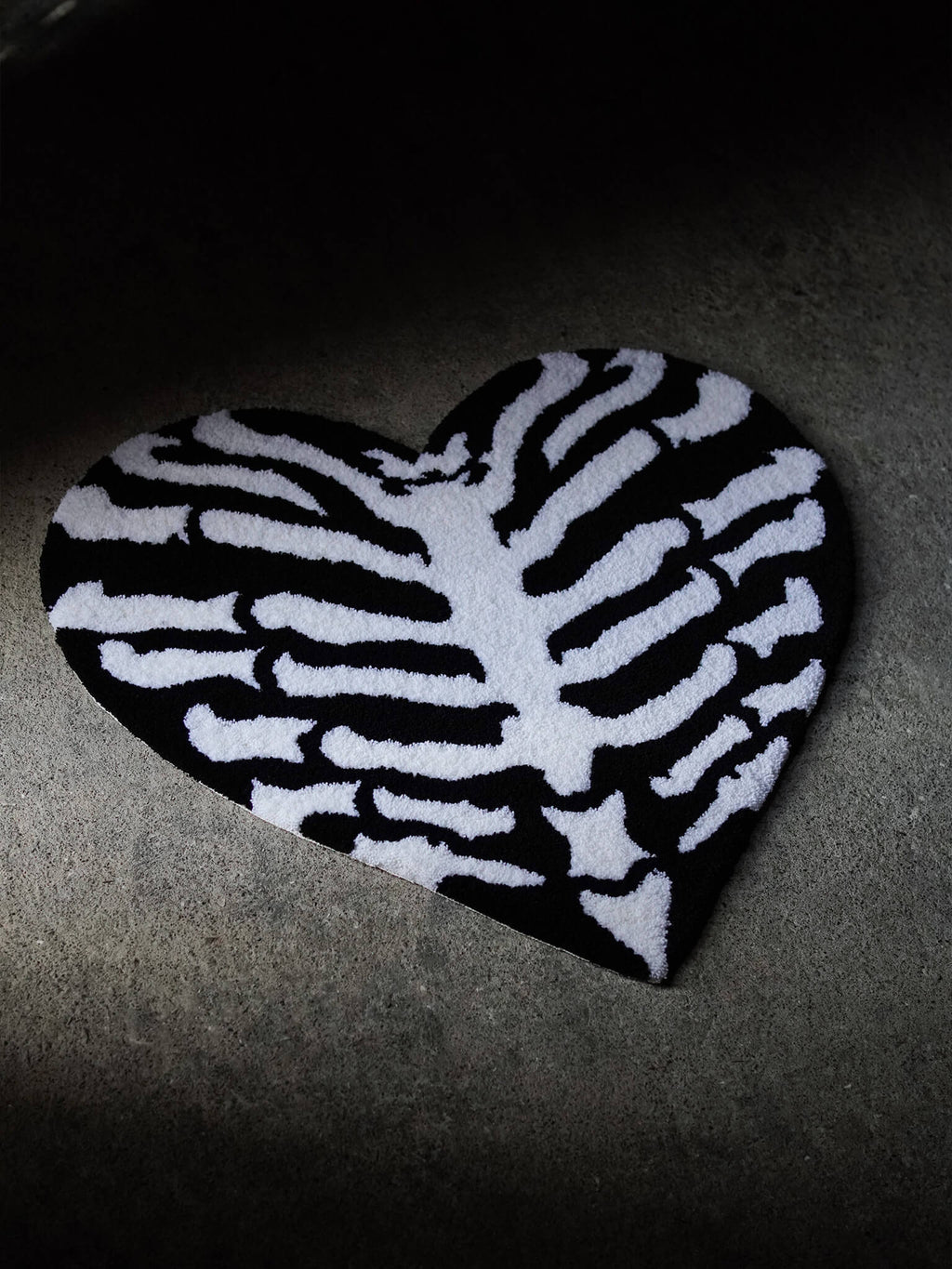 Angled view of the Ribcage Heart Rug showing premium handcrafted texture.