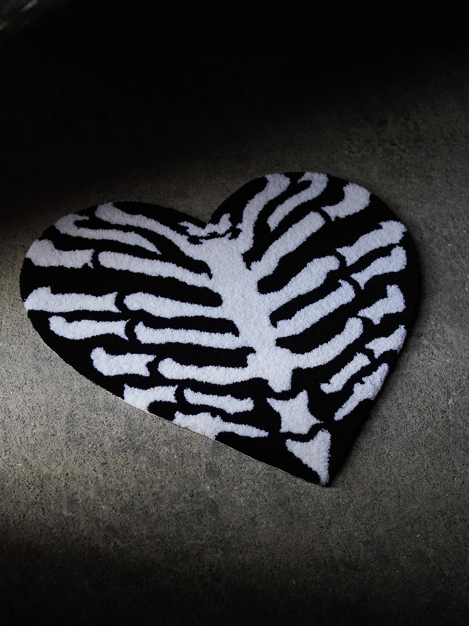Angled view of the Ribcage Heart Rug showing premium handcrafted texture.
