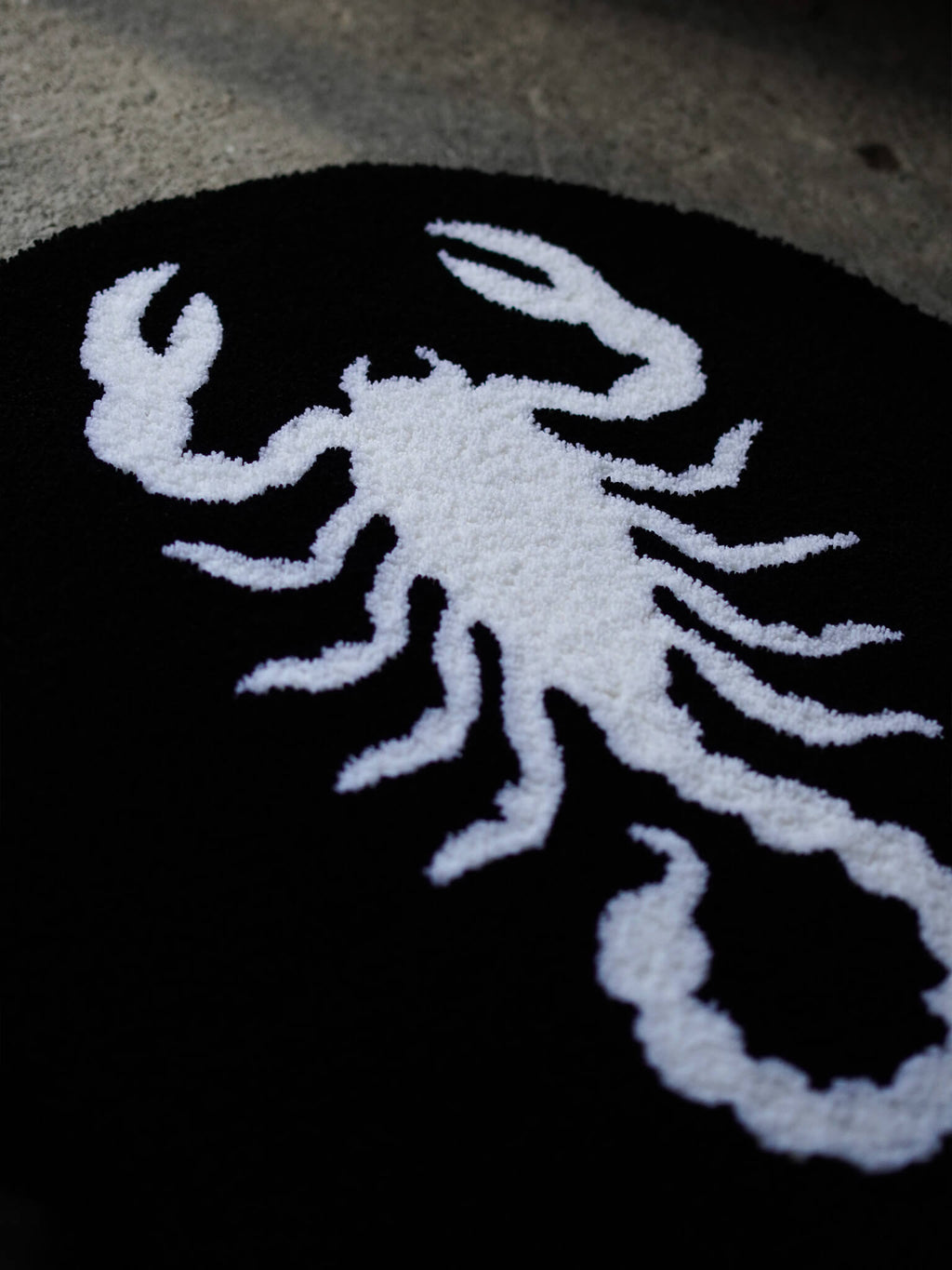 Side perspective of the Scorpion rug, revealing the tactile depth of the hand-tufted legs.