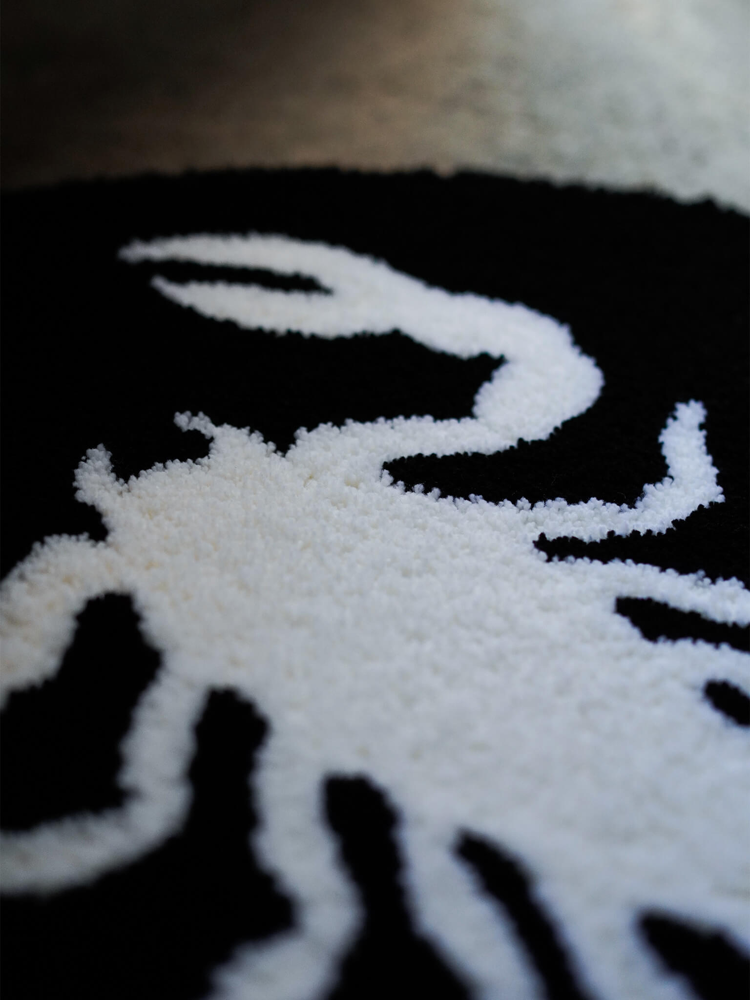 Close-up texture of the Scorpion rug, showing the raw blackwork aesthetic and premium Japanese hand-tufting.