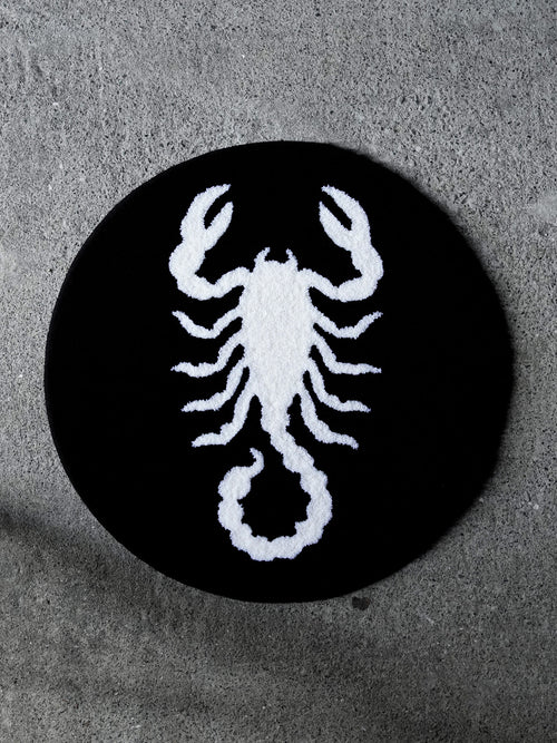 The Scorpion Circle Rug. A bold, stark-white scorpion icon against a solid black background.