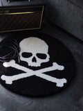 Skull and Crossbones circle rug grounding a dark living space with an amplifier and a sofa.