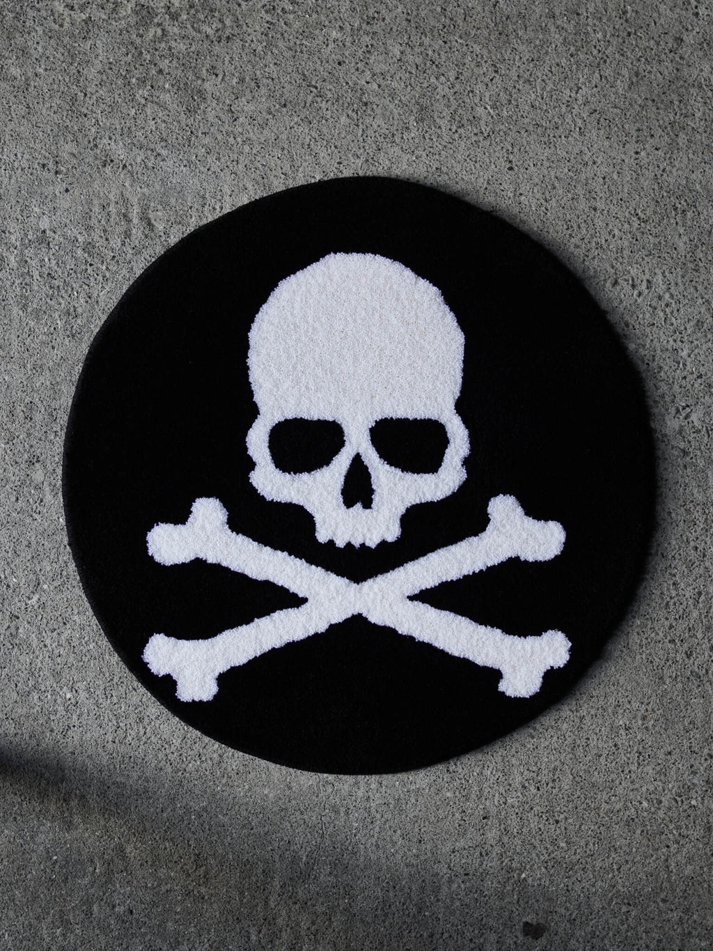 The Skull and Crossbones Circle Rug. A clean, classic underground tattoo design tufted in heavy black and white.