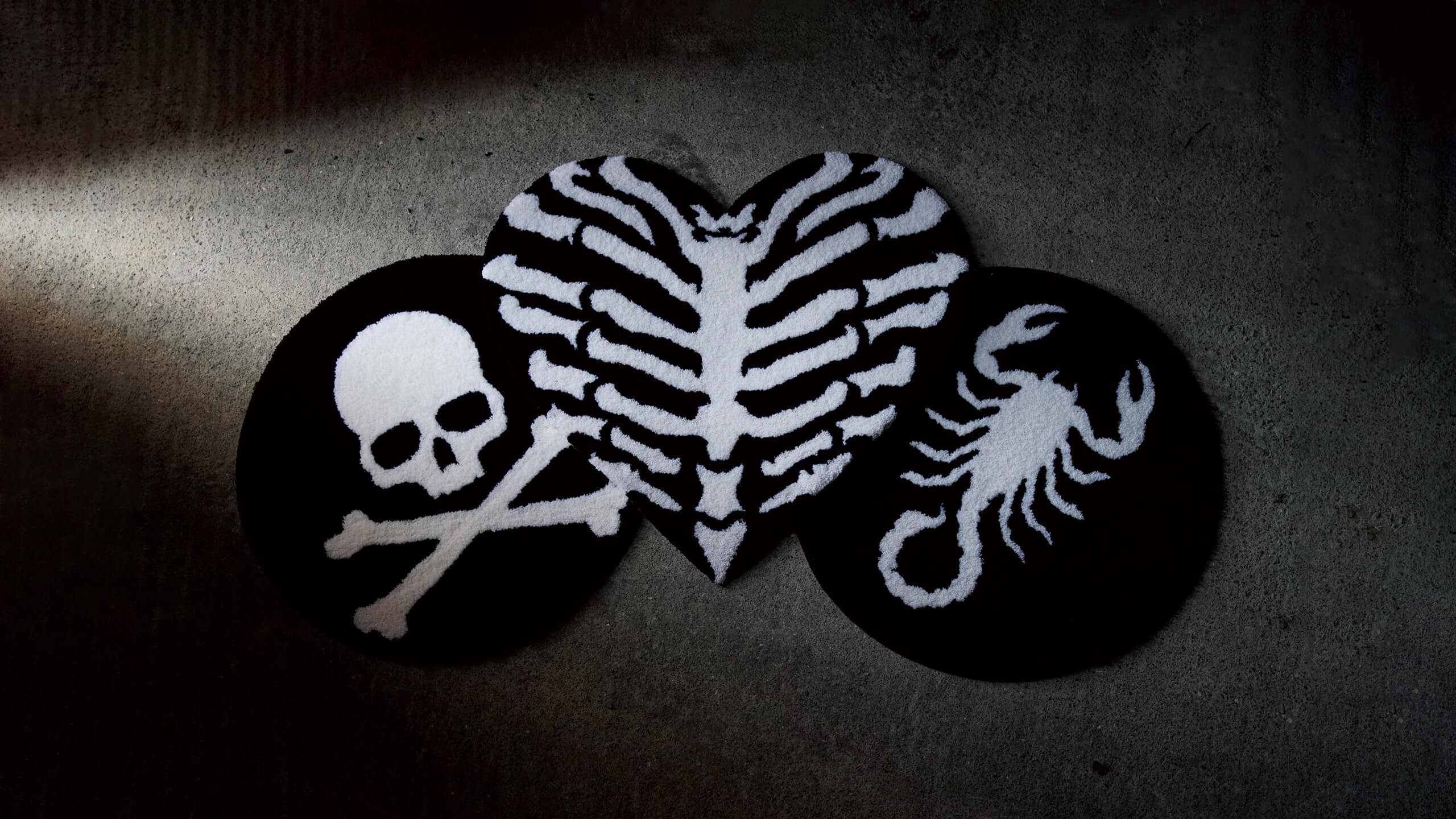 Void Rugs Drop 001 collection featuring the Ribcage Heart, Scorpion, and Skull & Crossbones rugs. Limited run, tattoo-inspired alternative rugs handcrafted in Japan.